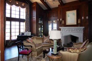 Elegant Living Room of High-End home featuring high ceilings, wood paneling and grand piano