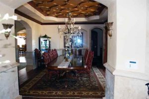 Audio - Video - Control Systems - Dining Room with ceiling speakers installed and a beautiful ceiling, crystal chandelier and table.