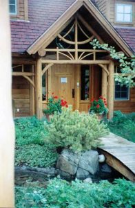 Photo of entry to mountain log home in Aspen with garden and flowers