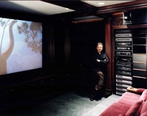 High-End Home Theater showing Randy Loyd at equipment rack Audio, Video, and Control Systems