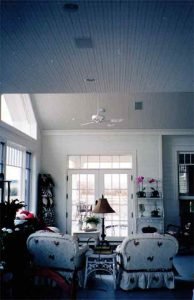 Home seating area with ceiling speakers installed and Touchpanel control for Audio, Video, and Control Systems