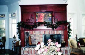 Living Room with ceiling speakers and television installed in rolling door cabinet Audio, Video, and Control Systems