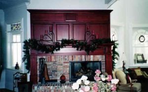 Living Room with ceiling speakers and television installed in rolling door cabinet Audio, Video, and Control Systems