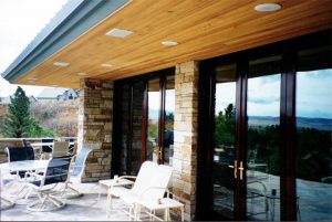 Exterior of lovely home showing outdoor speakers installed in soffit and Touchpanel control for Audio, Video, and Control Systems